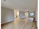 Open-concept living area with hardwood floors and seamless flow to kitchen at 132 Garden Manor Ct, Loganville, GA 30052