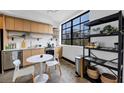 Contemporary kitchen featuring light wood cabinets, stainless appliances, and a view from a large window at 1805 Harvard Ave # 207, College Park, GA 30337