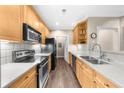 Well-lit kitchen with stainless steel appliances, tiled backsplash, and wood cabinets at 2103 Stratford Commons, Decatur, GA 30033