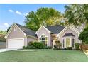 Stunning home featuring green lawn, stone accents, and a two-car garage at 705 Branch Tree Way, Lawrenceville, GA 30043