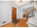 Inviting entryway with hardwood floors, a wooden front door, and access to the living area at 401 Briardale Court, Woodstock, GA 30189