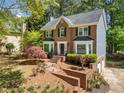 Beautiful two-story brick home with well-maintained landscaping and an attached garage at 401 Briardale Court, Woodstock, GA 30189
