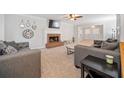 Spacious living room with a brick fireplace, plush carpeting, and neutral décor at 401 Briardale Court, Woodstock, GA 30189