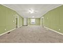 Large living area featuring neutral carpet, green walls, and ample space at 4653 Anns Se Trce, Acworth, GA 30102