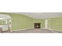 Spacious living room with green walls, carpeted floors, and a cozy brick fireplace at 4653 Anns Se Trce, Acworth, GA 30102
