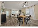 Open-concept living area with wood floors, a dining space, and lots of natural light at 536 Crestridge Ct, Stone Mountain, GA 30083