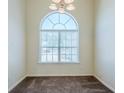 Bright dining area features large windows providing ample natural light and plush carpeting at 811 Betsy Ross Trl, Hampton, GA 30228