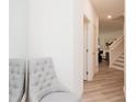 Bright hallway features a tufted chair, mirror, and views into adjacent rooms, offering a blend of comfort and style at 1573 Aiden Way # 37, Conyers, GA 30013