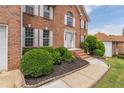 Inviting front entrance featuring a brick facade, manicured landscaping, and a classic white door at 1241 Hogan Ridge Ct, Grayson, GA 30017