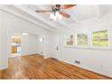 Bright living room featuring hardwood floors, a ceiling fan, and freshly painted walls with view into kitchen at 2037 Lenox Ne Rd, Atlanta, GA 30324