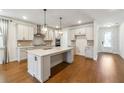 Bright kitchen features an island, granite countertops, and stylish pendant lighting at 2526 Knob Creek Dr, Snellville, GA 30078