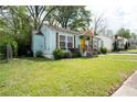 Charming home featuring a cheerful yellow door, window boxes, and a well-manicured front yard at 3078 Semmes St, East Point, GA 30344