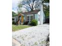 Charming home with light blue siding, a cheerful yellow front door, and a well-maintained yard at 3078 Semmes St, East Point, GA 30344