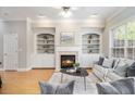 Inviting living room with a fireplace, built-in bookshelves, and a large window at 3499 Henderson Reserve, Atlanta, GA 30341