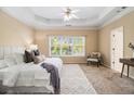 Serene main bedroom featuring a trey ceiling and a large window with natural light at 3499 Henderson Reserve, Atlanta, GA 30341