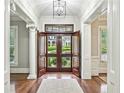 Inviting entryway with hardwood floors, white trim, and views of the lush front yard at 385 Laurel Chase Ct, Atlanta, GA 30327