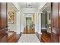 Elegant foyer with hardwood floors, white columns, a neutral palette, and sophisticated lighting at 385 Laurel Chase Ct, Atlanta, GA 30327
