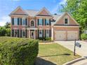 Elegant two-story brick home with lush landscaping and a spacious driveway at 3295 Millwood Se Trl, Smyrna, GA 30080