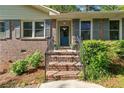 Close up of brick steps with potted plants leading up to the blue front door at 3982 Battleford Ct, Atlanta, GA 30341