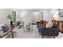 Bright living room with neutral paint, modern furniture, and plush white carpeting at 3982 Battleford Ct, Atlanta, GA 30341