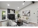 Cozy living room features a black stone fireplace with white mantel and patio access at 4983 Needle Knob Ct, Lithonia, GA 30038