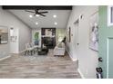 Bright living room boasts a fireplace, beamed ceilings, neutral tones, and an open doorway to the kitchen at 4983 Needle Knob Ct, Lithonia, GA 30038