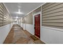 Hallway view of condo with neutral decor and a red front door at 2700 Pine Tree Ne Rd # 1015, Atlanta, GA 30324