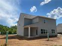 Back of home with covered porch, gray siding and a view of the yard at 4556 Sweetlake Sw Ct, Mableton, GA 30126