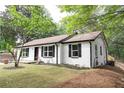 Beautifully landscaped one-story home featuring a new back deck and renovated exterior paint at 6881 Homestead Rd, Rex, GA 30273