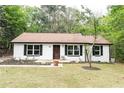 Charming one-story home featuring freshly painted exterior, new front door, and freshly landscaped yard at 6881 Homestead Rd, Rex, GA 30273