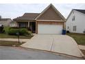 Charming home featuring a two-car garage, stone accents, and well-maintained landscaping at 115 Catlyn Ct, Riverdale, GA 30296