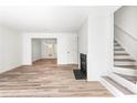 Bright living room features wood floors, a modern fireplace, and stairway at 197 Holcomb Ferry Rd, Roswell, GA 30076
