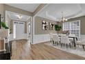 Elegant dining area boasts hardwood floors, decorative molding, and a modern chandelier at 3401 Ravensworth Trce, Kennesaw, GA 30144