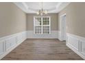 Dining area with hardwood floors, neutral paint, and decorative chair rail trim at 3401 Ravensworth Trce, Kennesaw, GA 30144