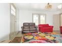A comfortable living room is accented by a colorful rug and neutral walls at 5024 Park Ave, Forest Park, GA 30297