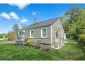 The house has gray siding and trim, as well as a green lawn surrounding it at 5024 Park Ave, Forest Park, GA 30297