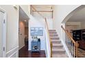 Spacious foyer with hardwood floors, staircase, and classic decor at 542 Simonton Ridge Trl, Lawrenceville, GA 30045