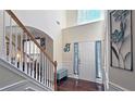 Bright foyer with hardwood floors, soaring ceilings, and staircase with white banisters at 542 Simonton Ridge Trl, Lawrenceville, GA 30045