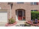 Close-up of front door with wreath and colorful landscaping at 542 Simonton Ridge Trl, Lawrenceville, GA 30045