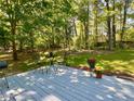 Back deck with outdoor seating and decorative flowers; perfect for entertaining at 1835 Penrose Ct, Powder Springs, GA 30127