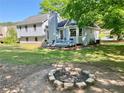 Spacious backyard featuring a fire pit, deck with patio set, and lush lawn at 1835 Penrose Ct, Powder Springs, GA 30127