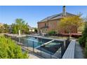 A backyard pool with a fence around it, a spa, and a lounge area, perfect for relaxation and entertainment at 2199 Tayside Nw Xing, Kennesaw, GA 30152