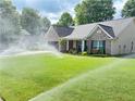 Exterior of charming home with lush lawn, sprinkler system, and inviting front porch seating at 4025 Mcdowell Dr, Acworth, GA 30101