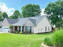 Well maintained single story home with brick and siding, manicured lawn, and inviting front porch at 4025 Mcdowell Dr, Acworth, GA 30101