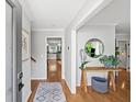 Inviting entryway with wood floors, a console table and a view of the kitchen beyond at 4841 Village North Ct, Atlanta, GA 30338