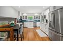Bright kitchen featuring stainless appliances, granite countertops, and white cabinets at 4841 Village North Ct, Atlanta, GA 30338