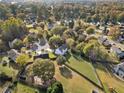 Aerial view of home showcasing large backyard, surrounding neighborhood, and proximity to a lake at 946 Steadman Ter, Marietta, GA 30064