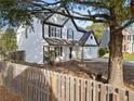 Charming two-story home with a well-manicured front yard, picket fence, and classic white siding at 946 Steadman Ter, Marietta, GA 30064