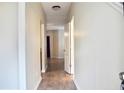Bright hallway with light-colored walls and luxury vinyl plank flooring, leading to multiple rooms at 2225 Bigwood Trl, Atlanta, GA 30349