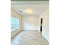 Sunlit living room with luxury vinyl plank flooring and a modern light fixture at 2225 Bigwood Trl, Atlanta, GA 30349